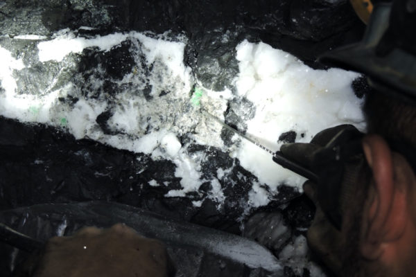 colombian-emerald An emerald being removed from a large-scale underground mine in Colombia. This is an example of a primary deposit where emeralds are hosted within veins. Photo courtesy of Muzo